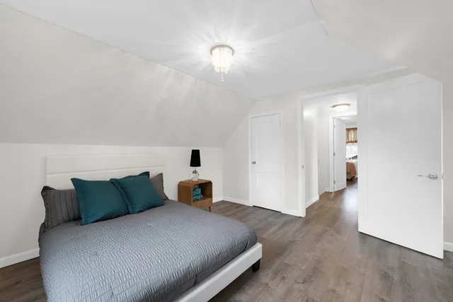 a bedroom with a bed and a lamp