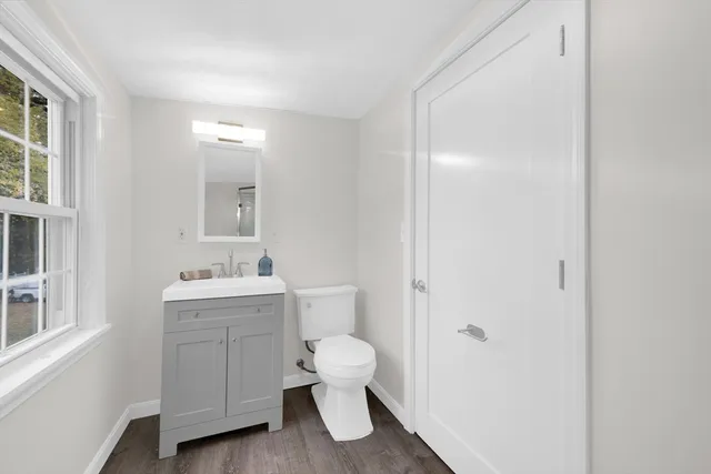 a bathroom with a toilet a sink and a window
