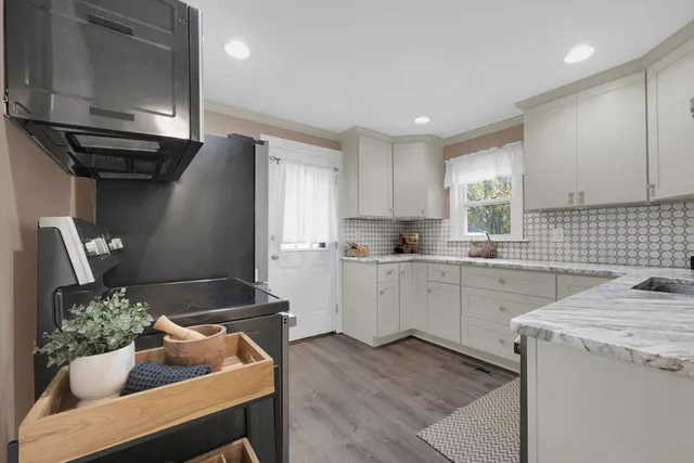 a kitchen that has a sink and a stove in it