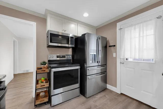 a kitchen with stainless steel appliances a refrigerator stove and microwave