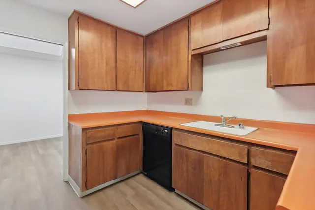 a kitchen with a sink and cabinets