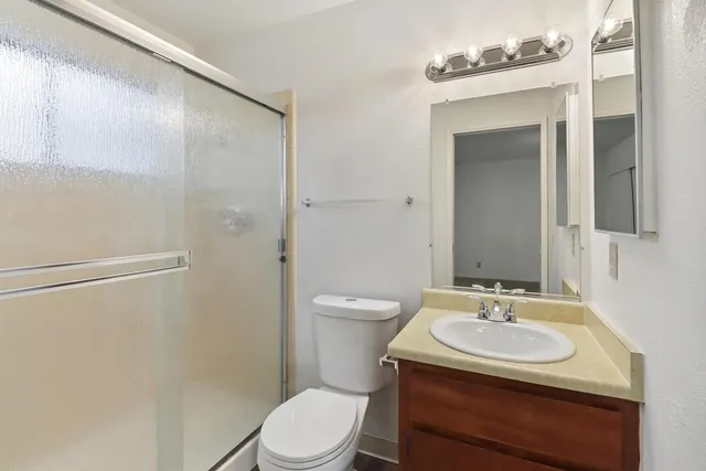 a bathroom with a shower and a toilet