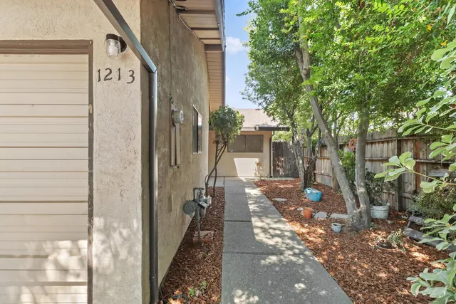 a view of a porch with wooden floor and a yard