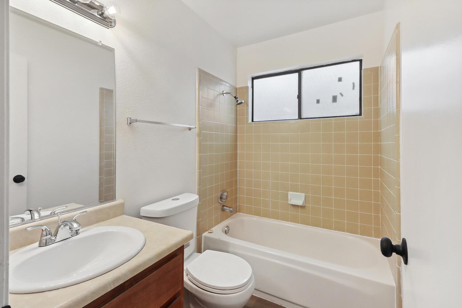 1213 Arthur Street Davis, CA 95616 - Photo 31 of 42 a bathroom with a granite countertop toilet sink and bathtub