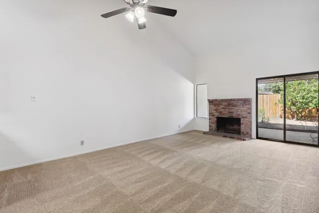 a view of an empty room with a fireplace