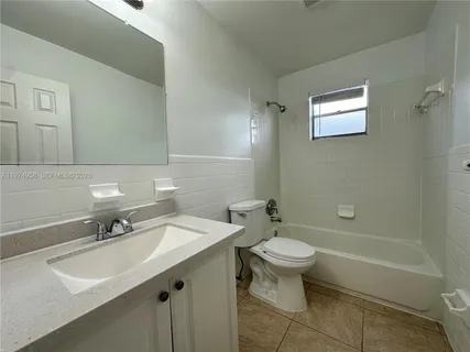a bathroom with a sink toilet and a mirror