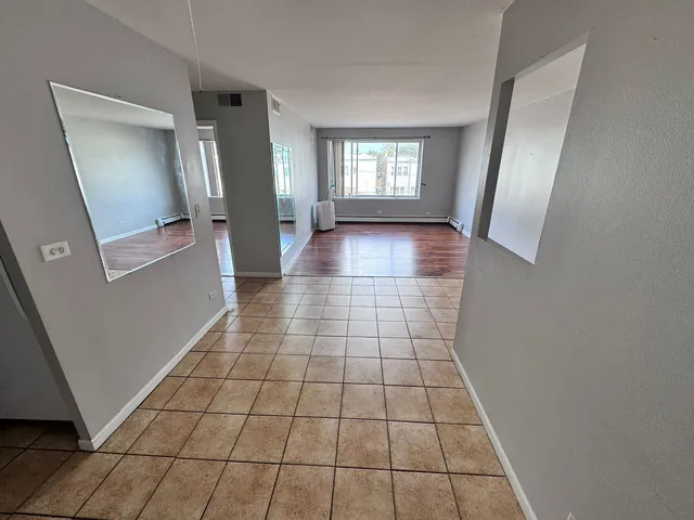 a view of a livingroom with wooden floor and a window