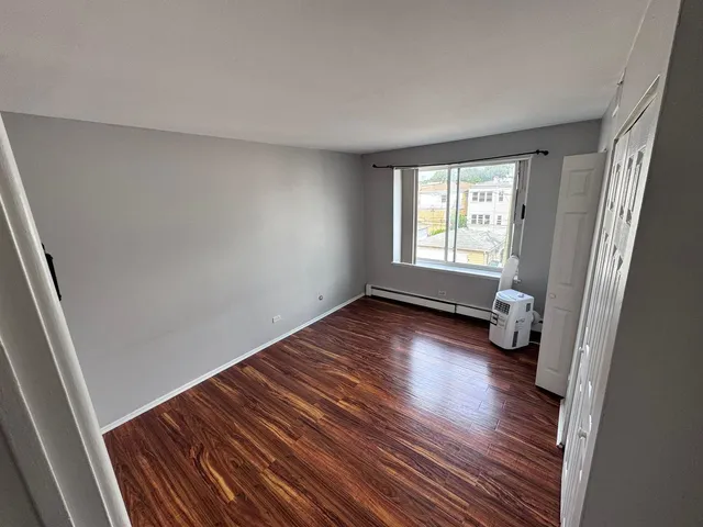 a view of room with hardwood floor and window