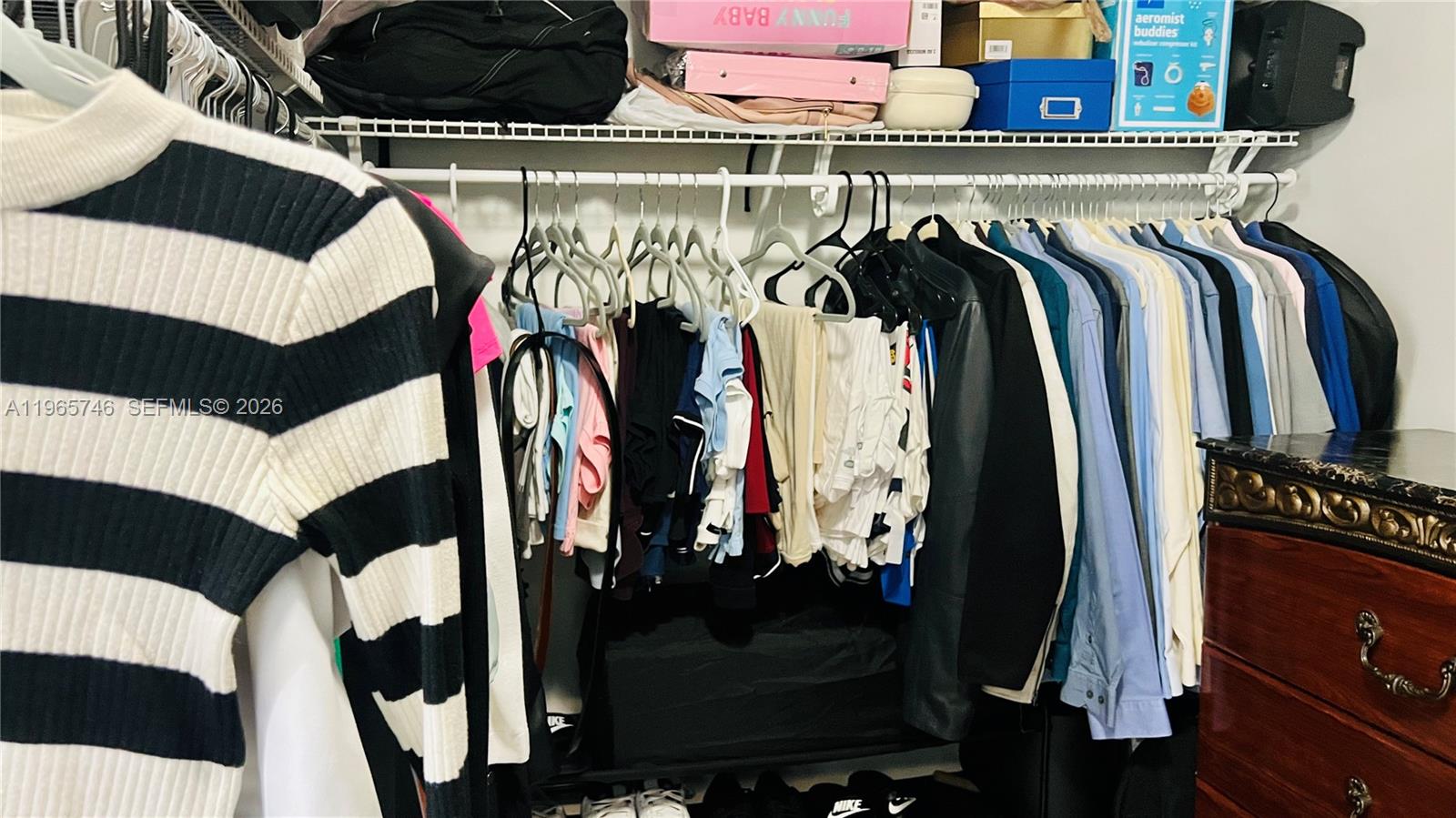 14250 Southwest 62nd Street, Unit 319 Miami, FL 33183 - Photo 11 of 29 a view of walk in closet with clothes and shoes