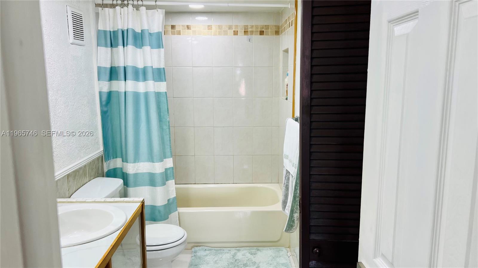 14250 Southwest 62nd Street, Unit 319 Miami, FL 33183 - Photo 12 of 29 a bathroom with a bathtub and shower