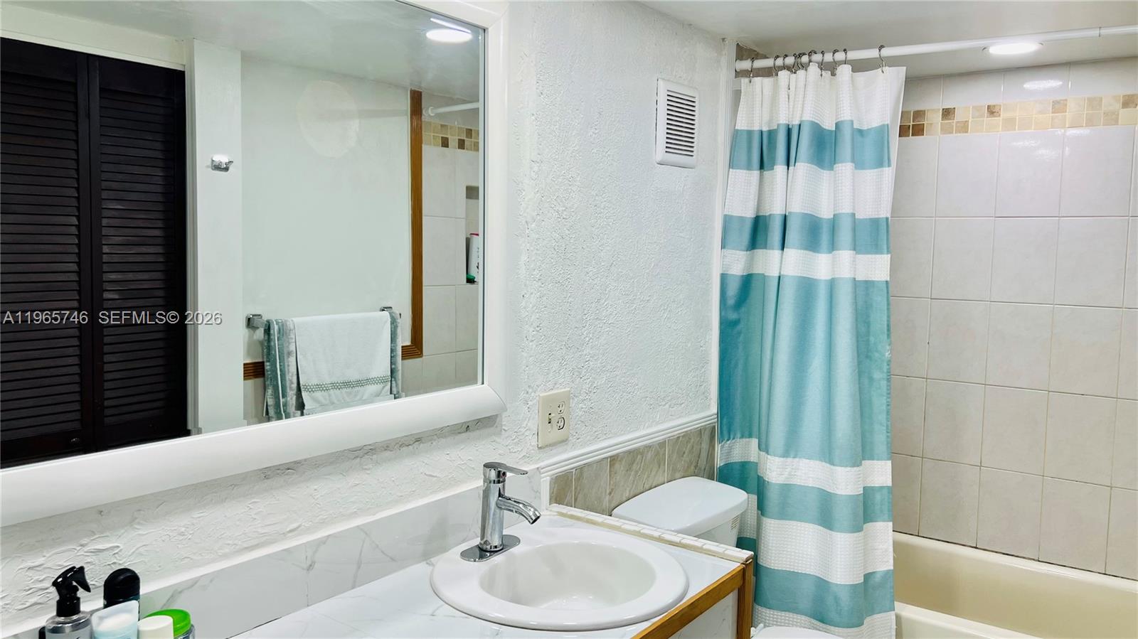 14250 Southwest 62nd Street, Unit 319 Miami, FL 33183 - Photo 13 of 29 a bathroom with a sink toilet and shower