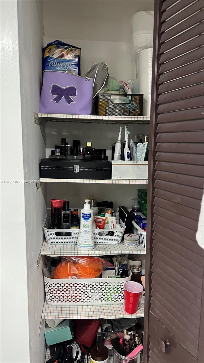 14250 Southwest 62nd Street, Unit 319 Miami, FL 33183 - Photo 14 of 29 a store room with lots of different colored cloths