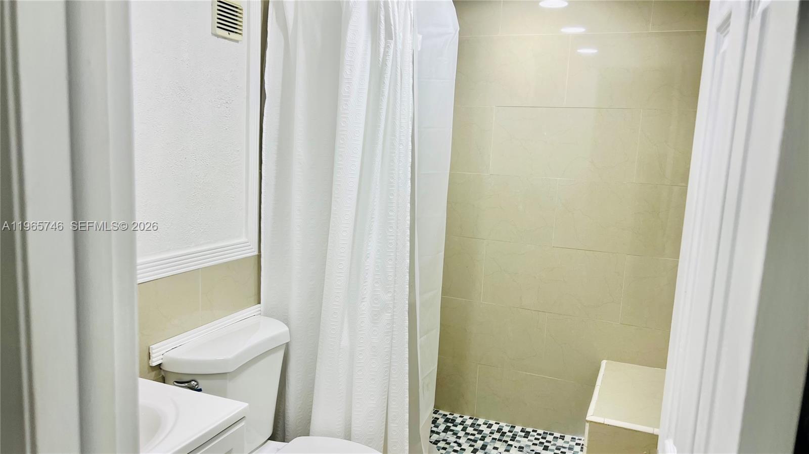 14250 Southwest 62nd Street, Unit 319 Miami, FL 33183 - Photo 16 of 29 a bathroom with a toilet and a shower