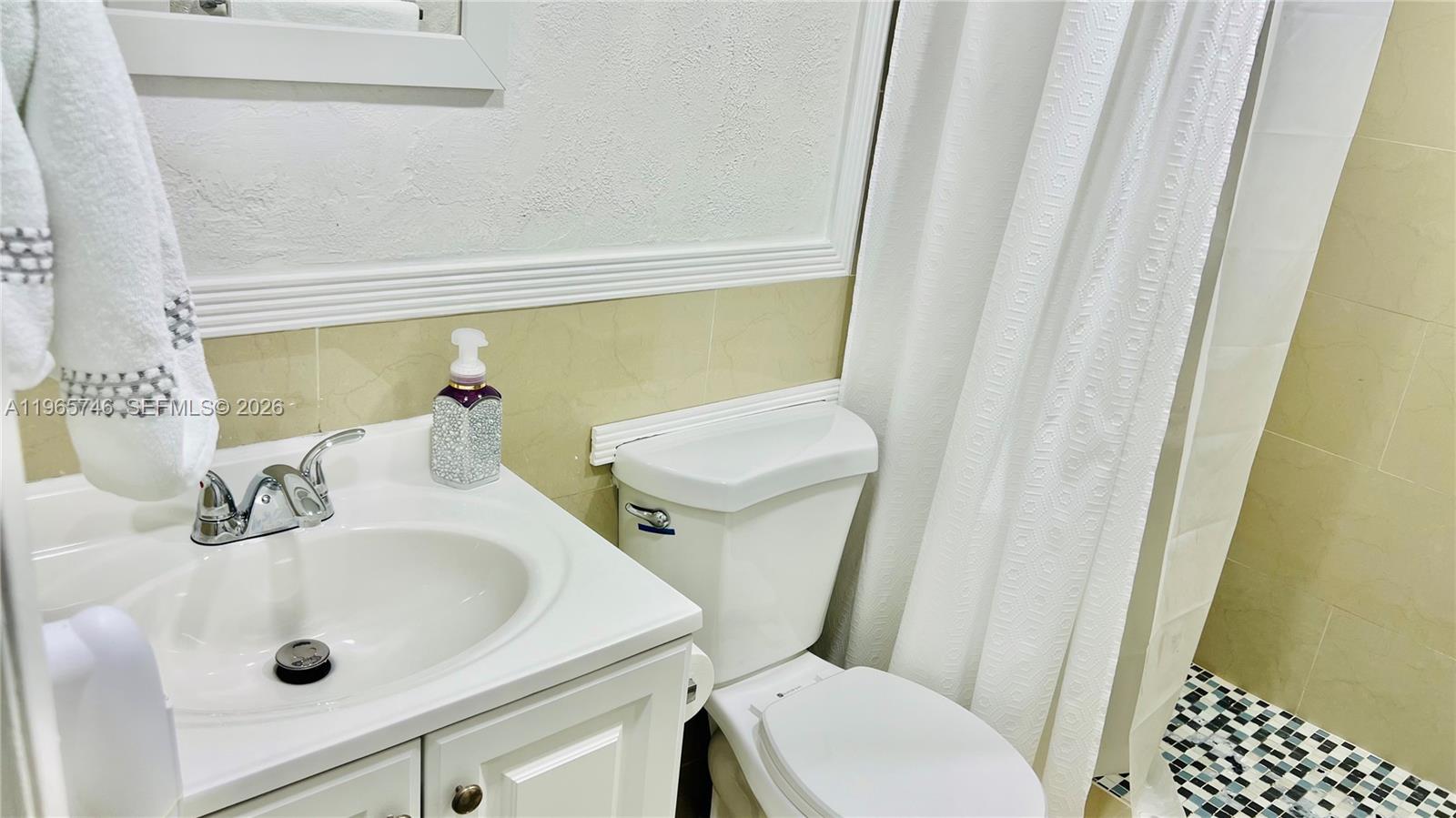 14250 Southwest 62nd Street, Unit 319 Miami, FL 33183 - Photo 17 of 29 a bathroom with a sink and a toilet
