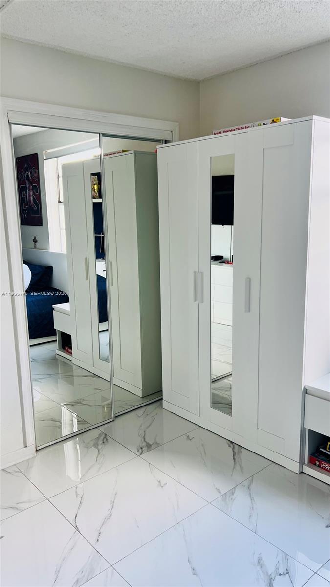 14250 Southwest 62nd Street, Unit 319 Miami, FL 33183 - Photo 19 of 29 a view of a hallway with wooden shelves