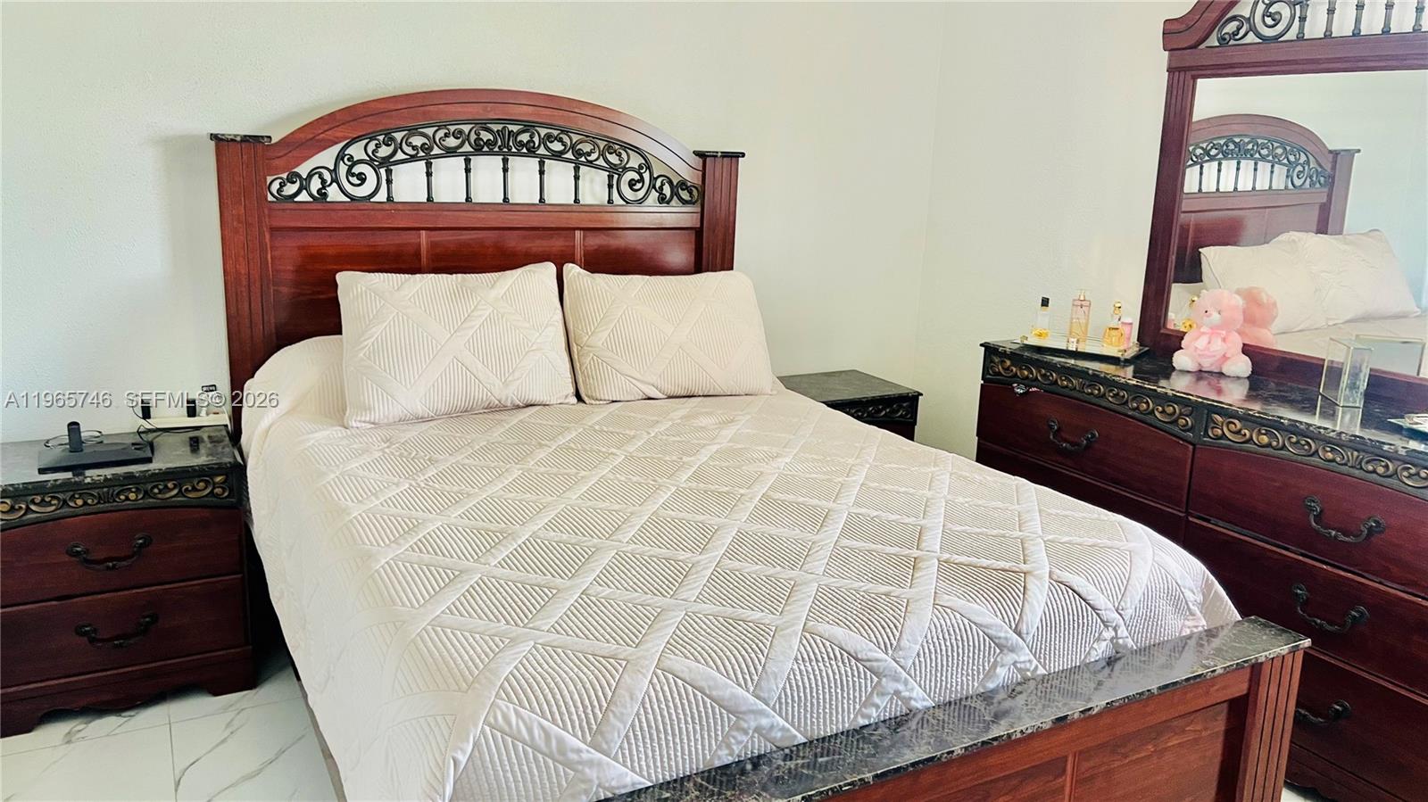 14250 Southwest 62nd Street, Unit 319 Miami, FL 33183 - Photo 20 of 29 a large bed sitting in a bedroom next to a dresser