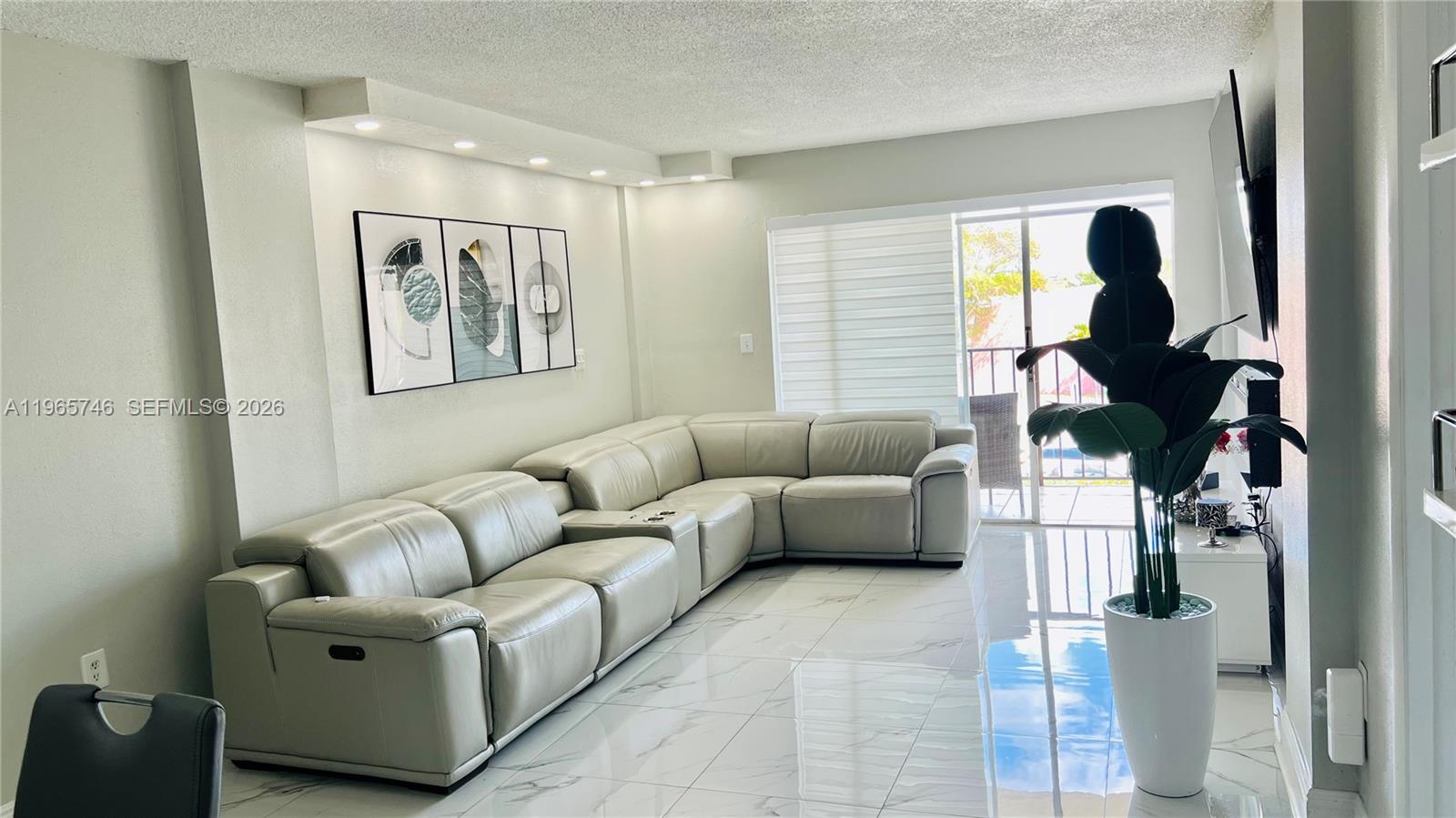 14250 Southwest 62nd Street, Unit 319 Miami, FL 33183 - Photo 2 of 29 a living room with furniture and a window