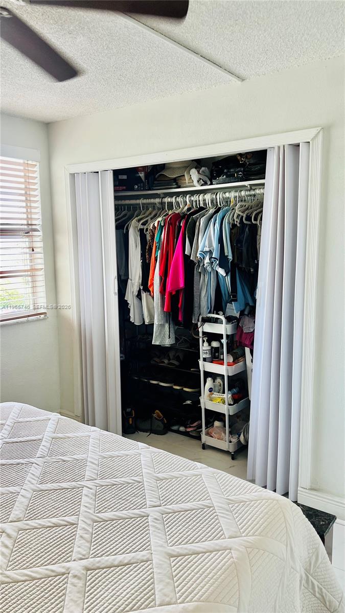 14250 Southwest 62nd Street, Unit 319 Miami, FL 33183 - Photo 21 of 29 a bedroom with a bed and a window