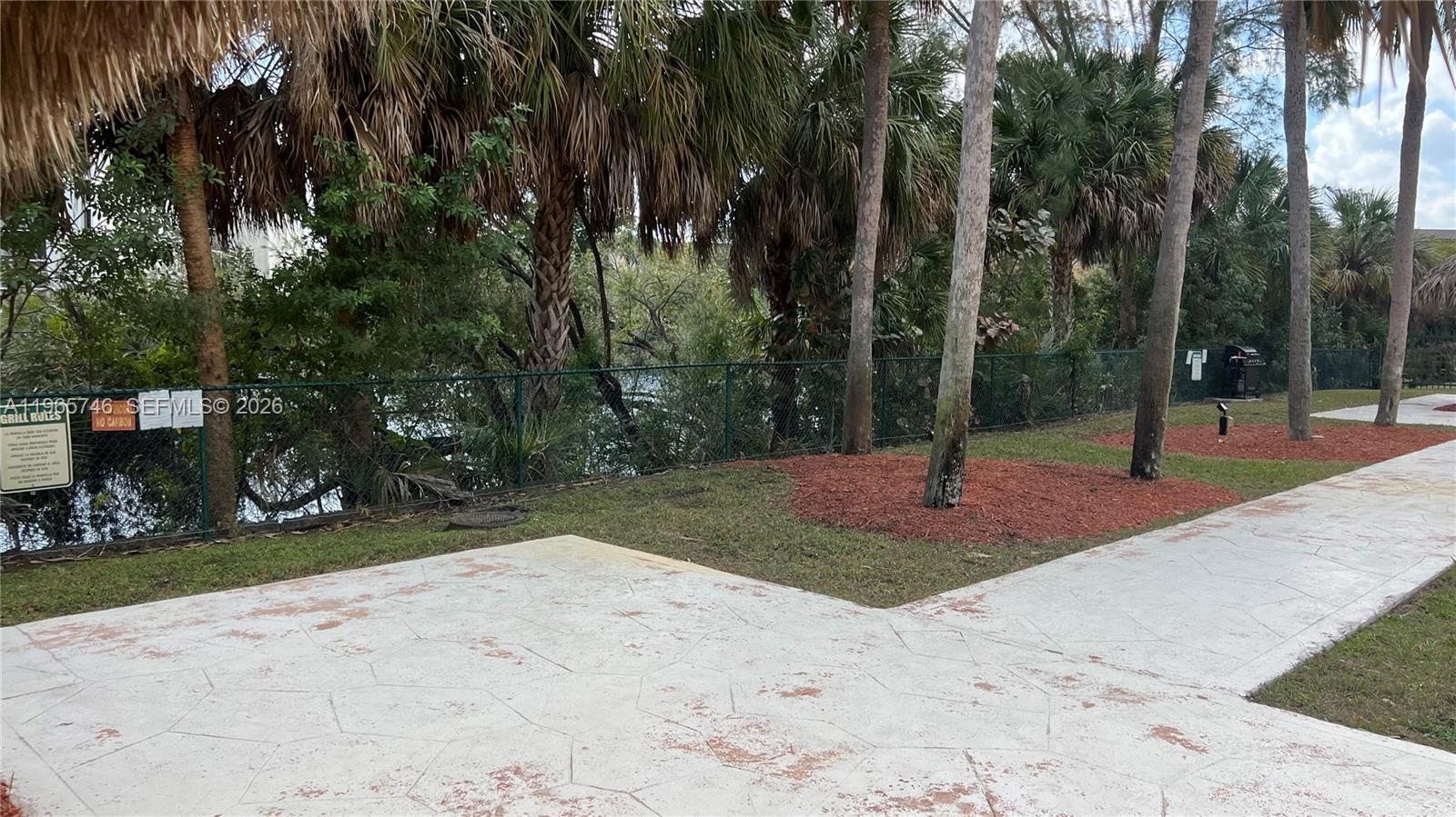 14250 Southwest 62nd Street, Unit 319 Miami, FL 33183 - Photo 28 of 29 a backyard of a house with lots of green space
