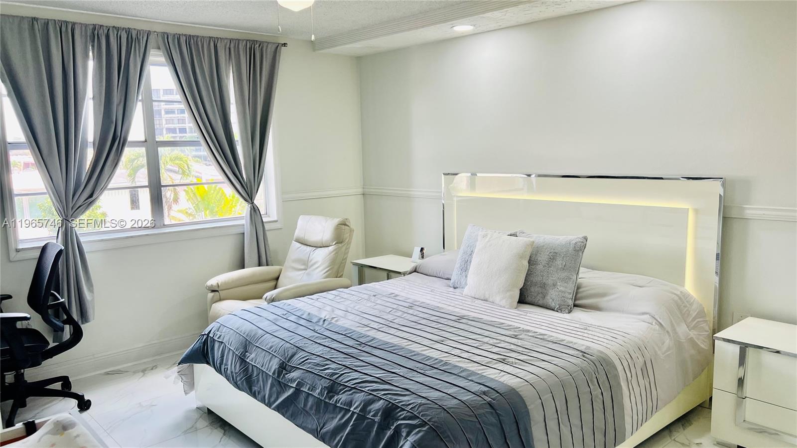 14250 Southwest 62nd Street, Unit 319 Miami, FL 33183 - Photo 9 of 29 a bedroom with a bed and a window