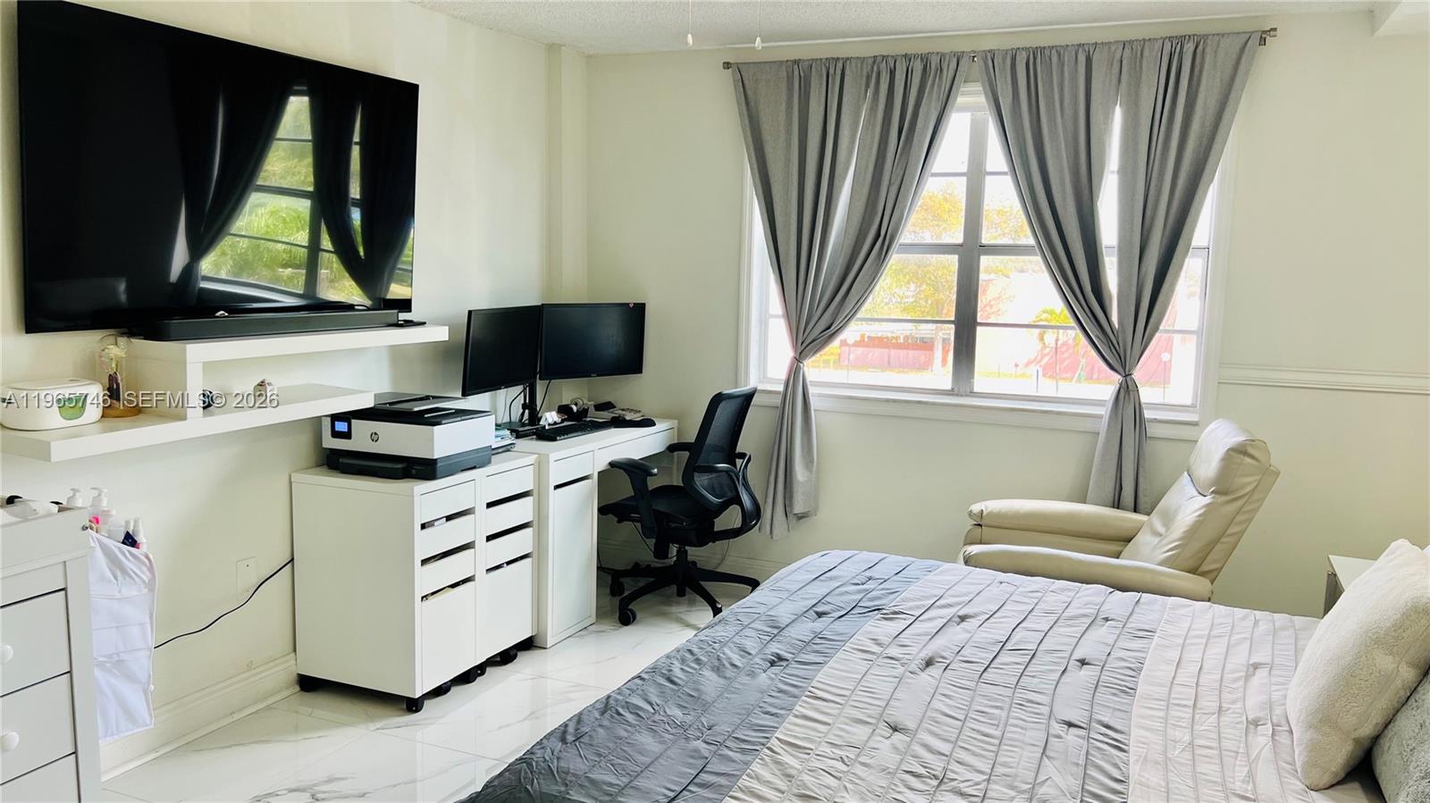 14250 Southwest 62nd Street, Unit 319 Miami, FL 33183 - Photo 10 of 29 a bedroom with a bed and a large window