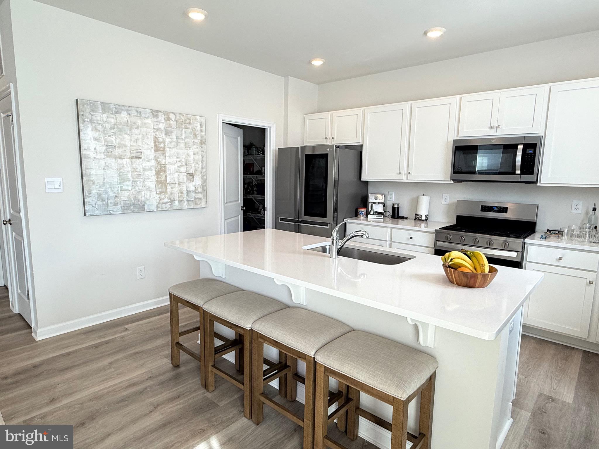 13 Outsail Avenue Barnegat, NJ 08005 - Photo 11 of 32 a kitchen with stainless steel appliances a dining table chairs and refrigerator