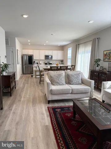 a living room with furniture and kitchen view
