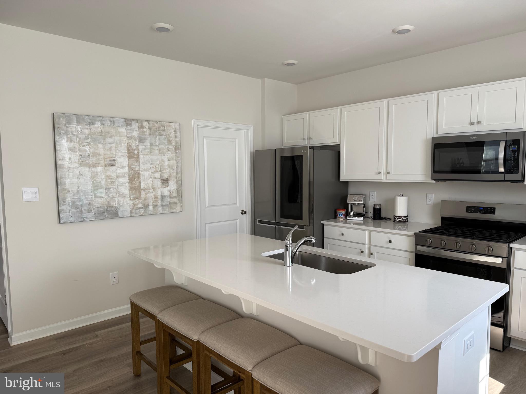 13 Outsail Avenue Barnegat, NJ 08005 - Photo 15 of 32 a kitchen with sink a microwave a refrigerator and cabinets