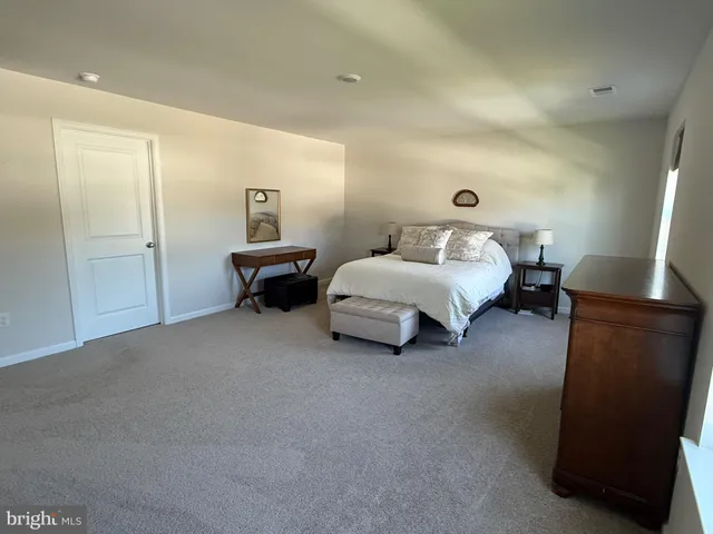 a bedroom with bed and window