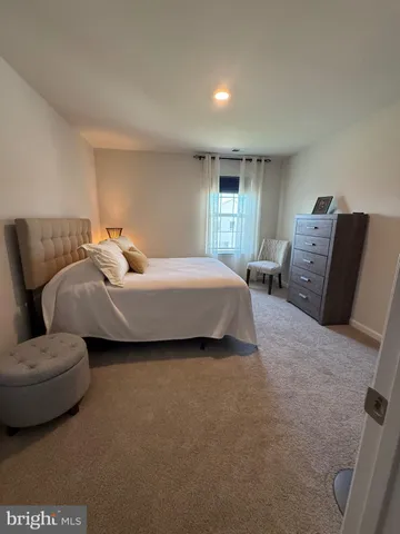 a spacious bedroom with a bed and window