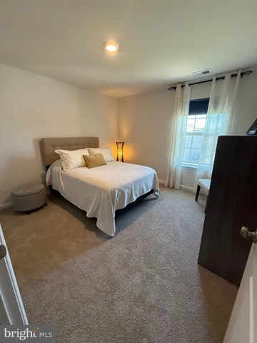 a bedroom with bed and window