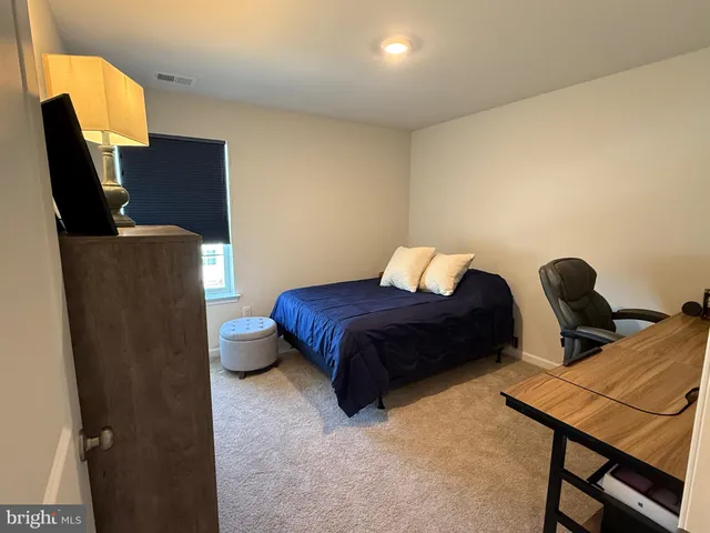 a bedroom with furniture and a chair