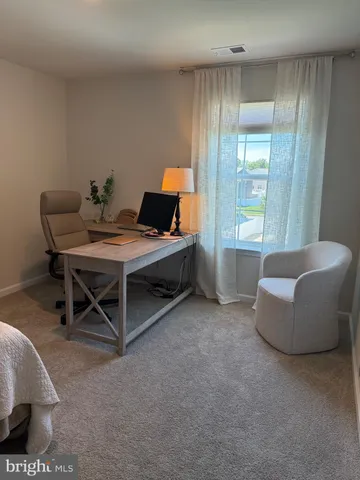 a workspace with furniture and window