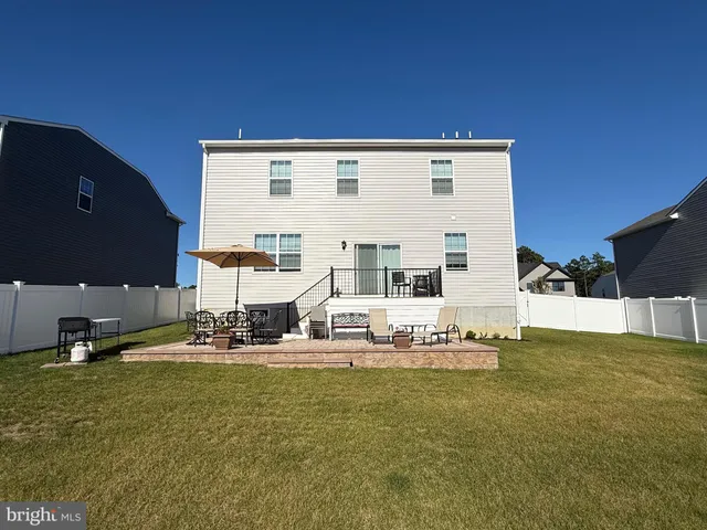 a table and chairs in front of a house