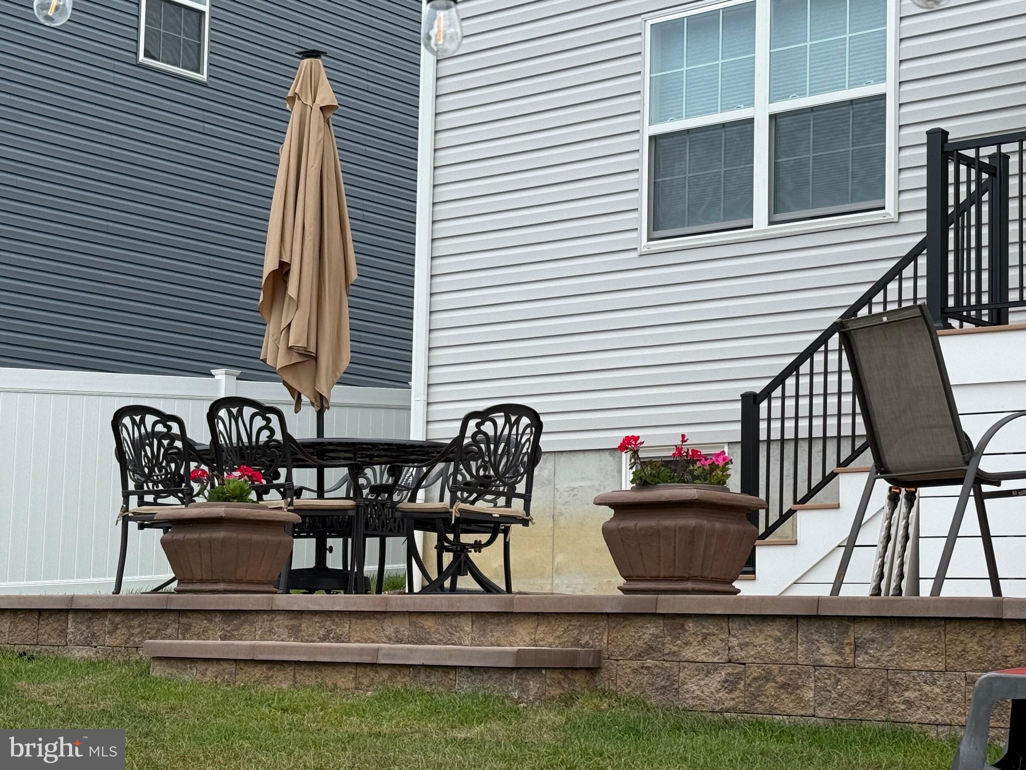 13 Outsail Avenue Barnegat, NJ 08005 - Photo 28 of 32 a table and chairs in front of a house