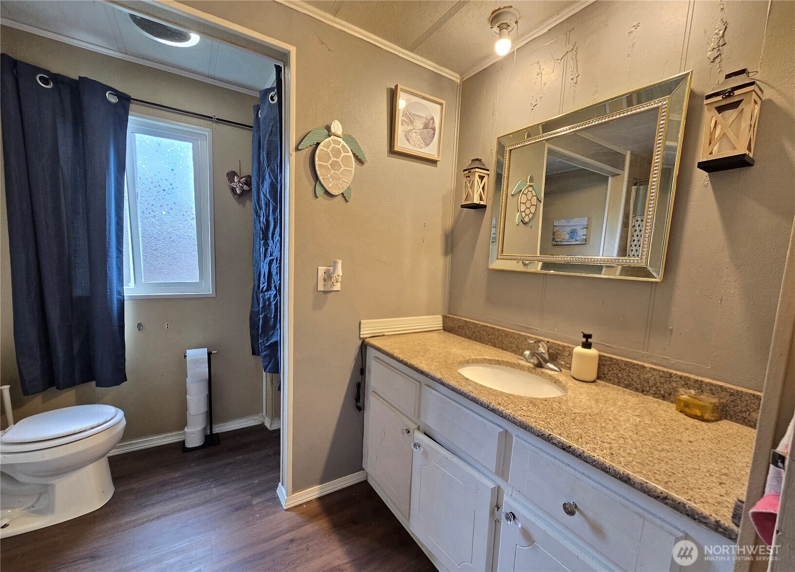 38 Hurd Road, Unit 35 Elma, WA 98541 - Photo 14 of 20 a bathroom with a granite countertop toilet sink and mirror