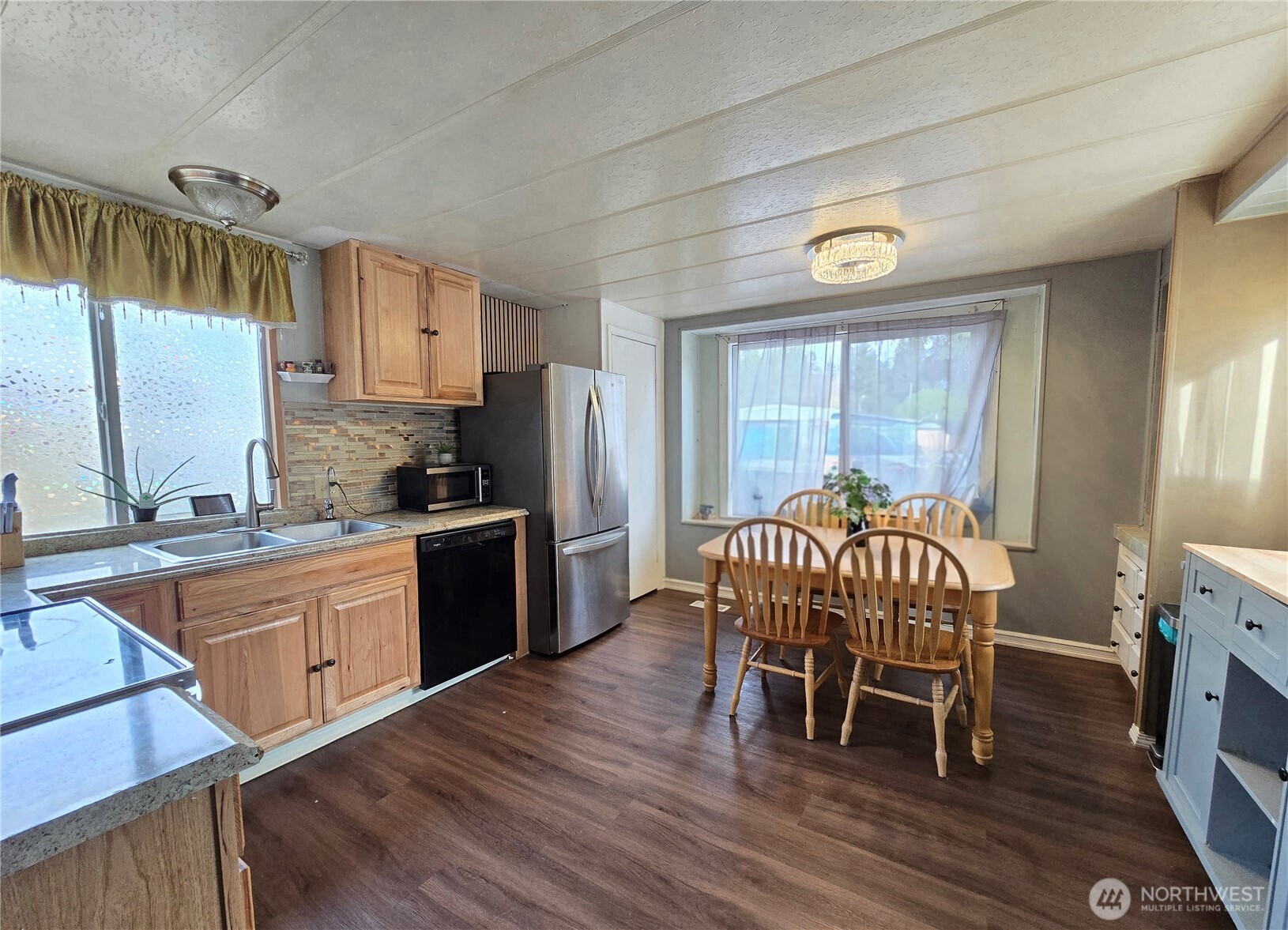 38 Hurd Road, Unit 35 Elma, WA 98541 - Photo 3 of 20 a kitchen with stainless steel appliances granite countertop a kitchen island hardwood floor and a sink