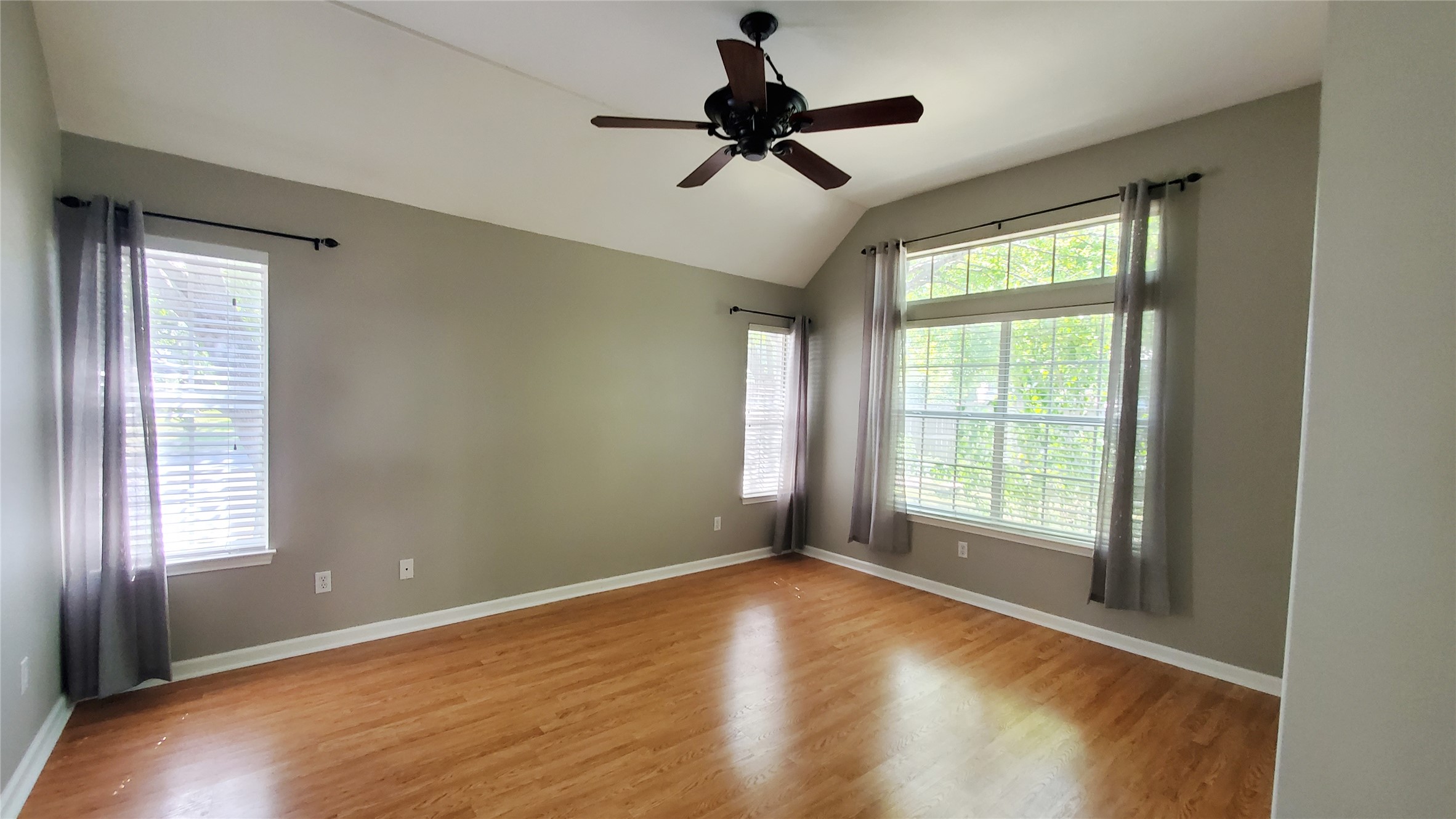 201 Rio Vista Drive Georgetown, TX 78626 - Photo 15 of 26 A well-lit bedroom with natural light, vaulted ceilings, and a modern ceiling fan.