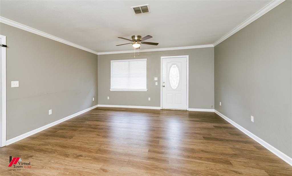 198 7 Pines Road Benton, LA 71006 - Photo 4 of 30 an empty room with wooden floor chandelier and windows