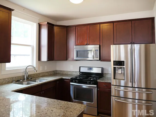 a kitchen with a refrigerator stove and sink