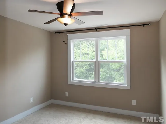 a room with a window and ceiling fan