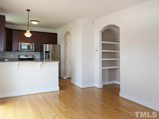 a view of a kitchen with a sink and a refrigerator