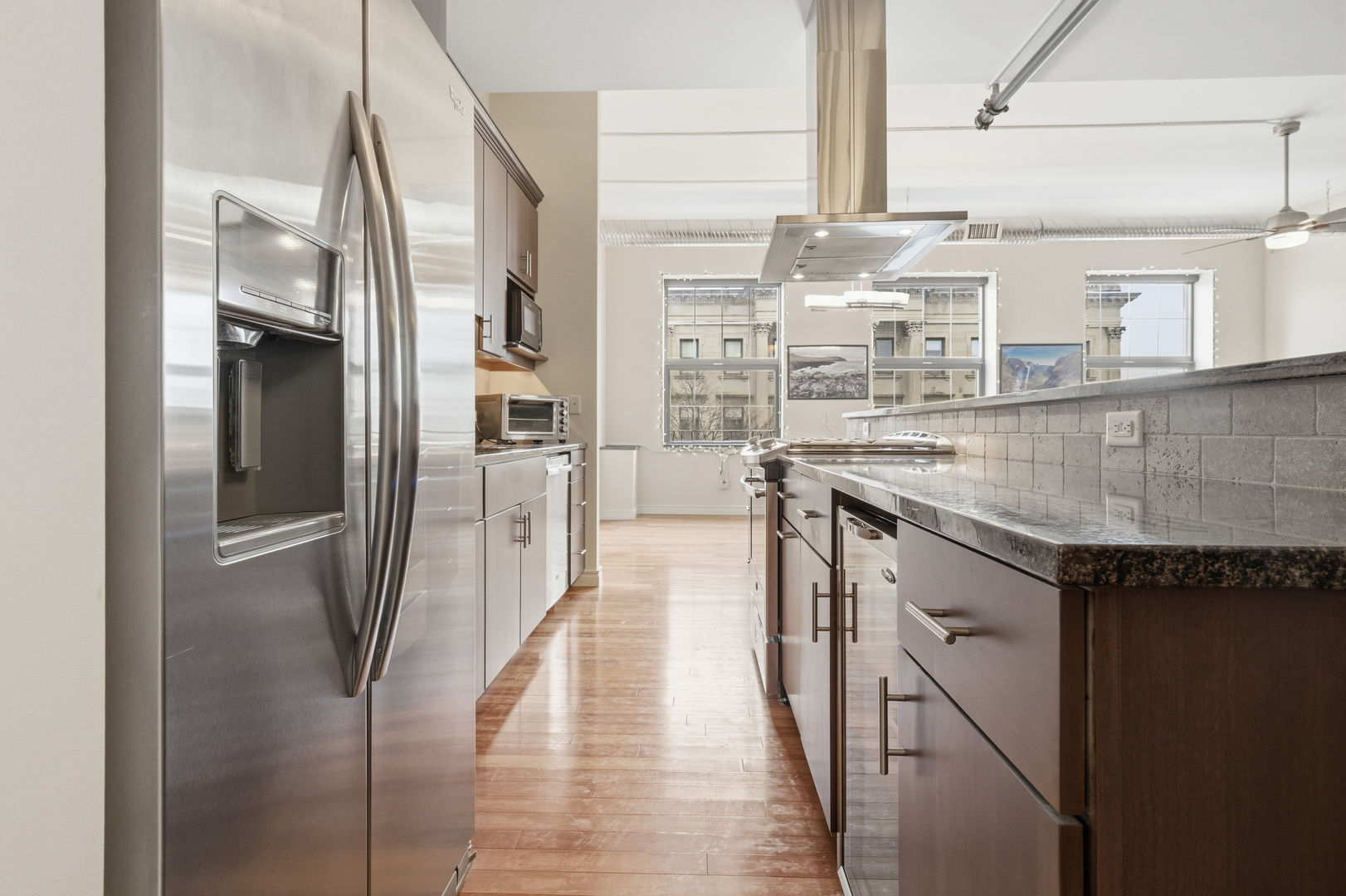 212 North Center Street, Unit 301 Bloomington, IL 61701 - Photo 16 of 39 a kitchen with stainless steel appliances granite countertop a refrigerator and a sink