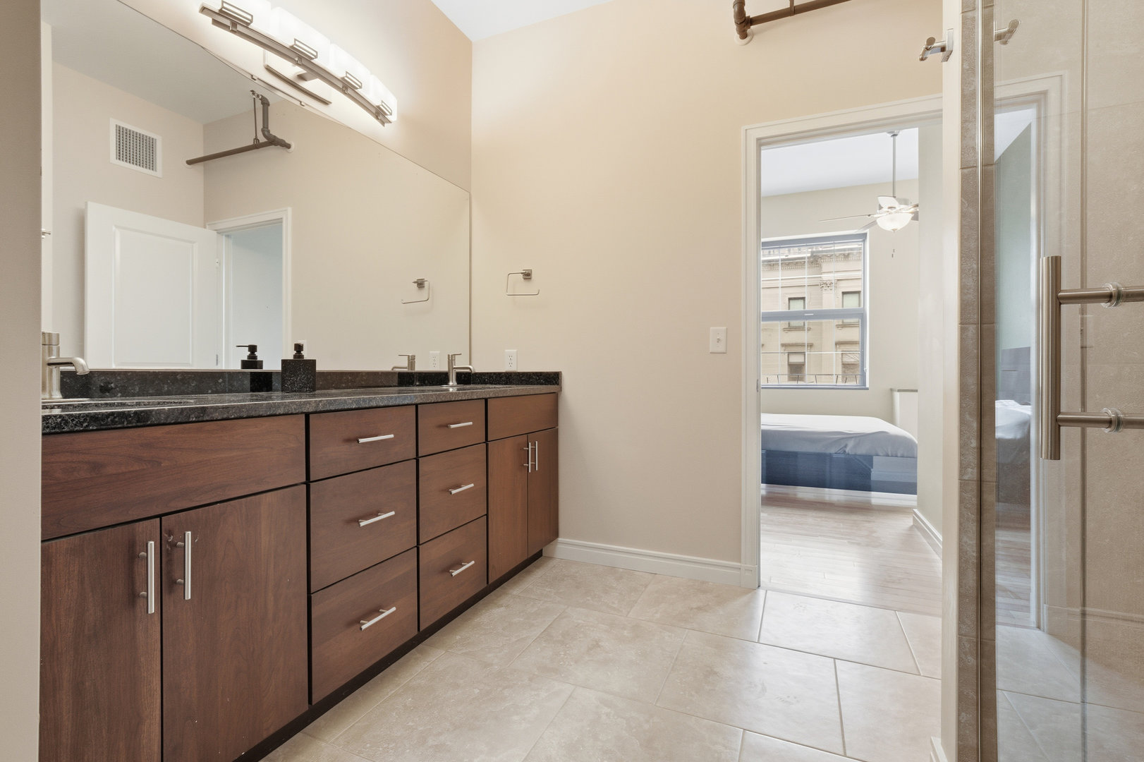 212 North Center Street, Unit 301 Bloomington, IL 61701 - Photo 30 of 39 a bathroom with a sink a vanity and a mirror