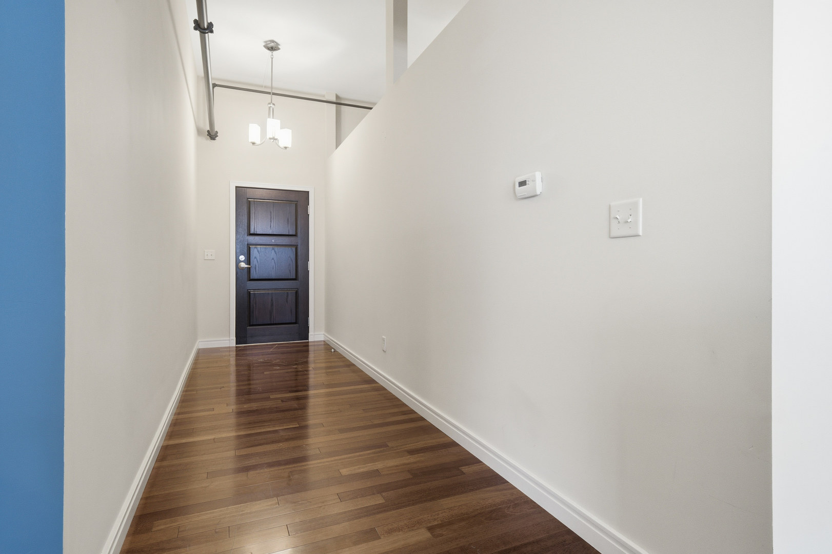 212 North Center Street, Unit 301 Bloomington, IL 61701 - Photo 3 of 39 a view of a hallway with wooden floor
