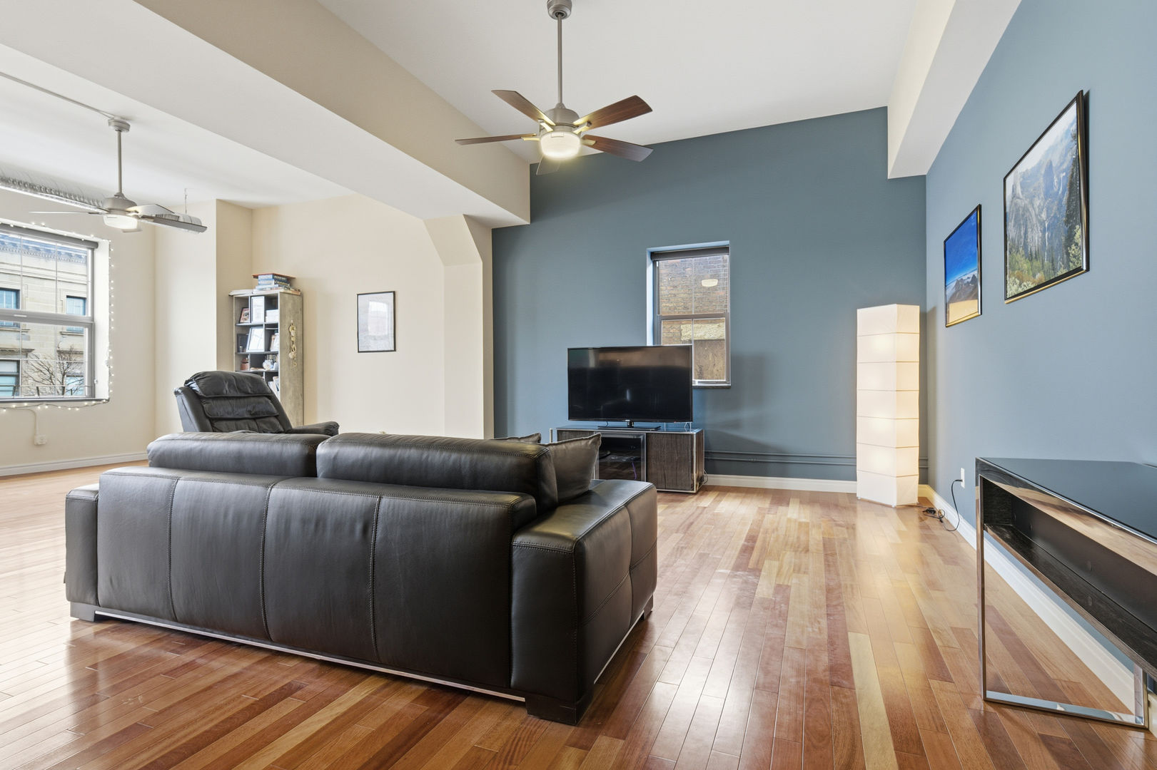212 North Center Street, Unit 301 Bloomington, IL 61701 - Photo 4 of 39 a living room with furniture and a flat screen tv