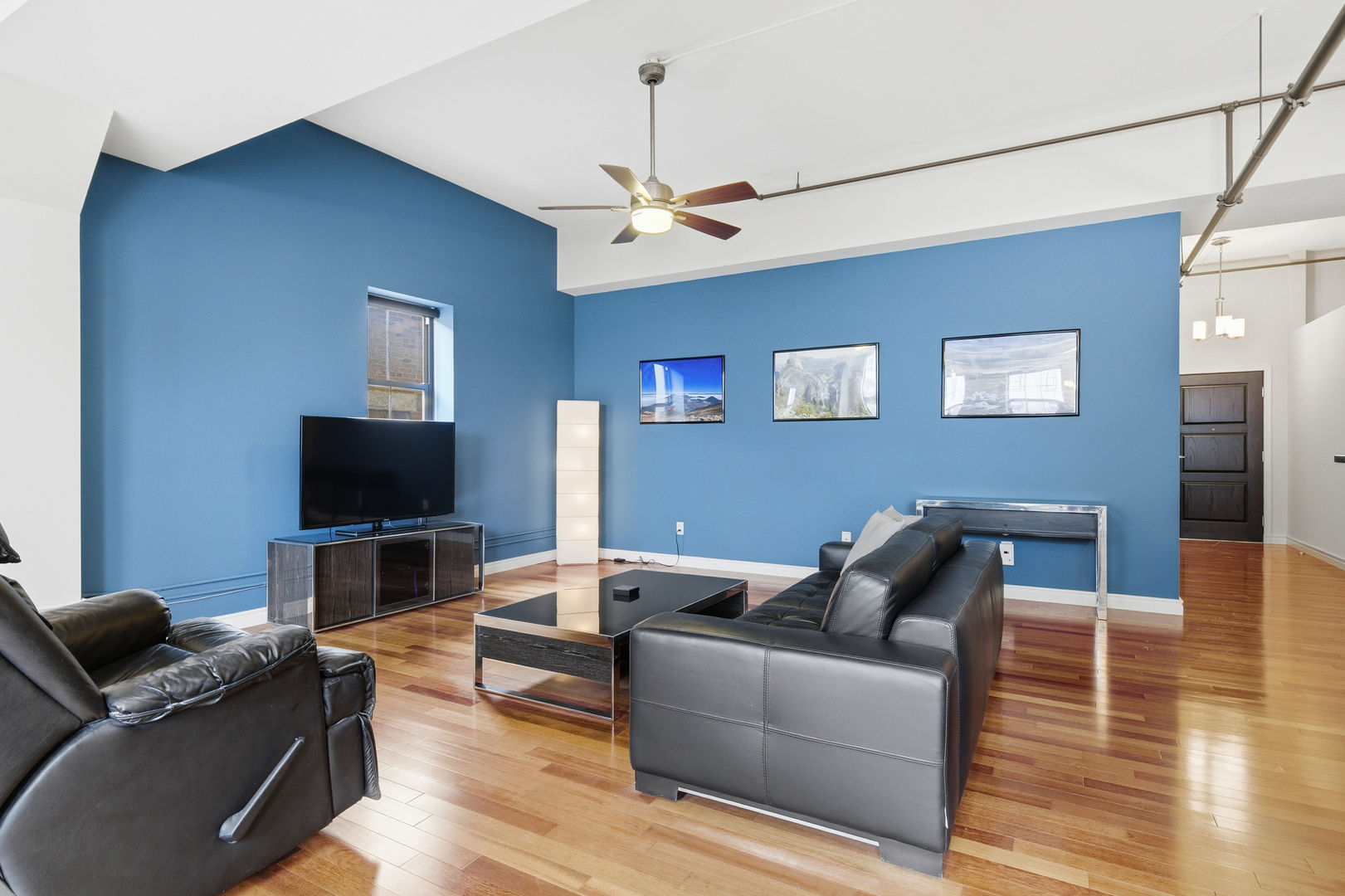 212 North Center Street, Unit 301 Bloomington, IL 61701 - Photo 6 of 39 a living room with furniture and a flat screen tv