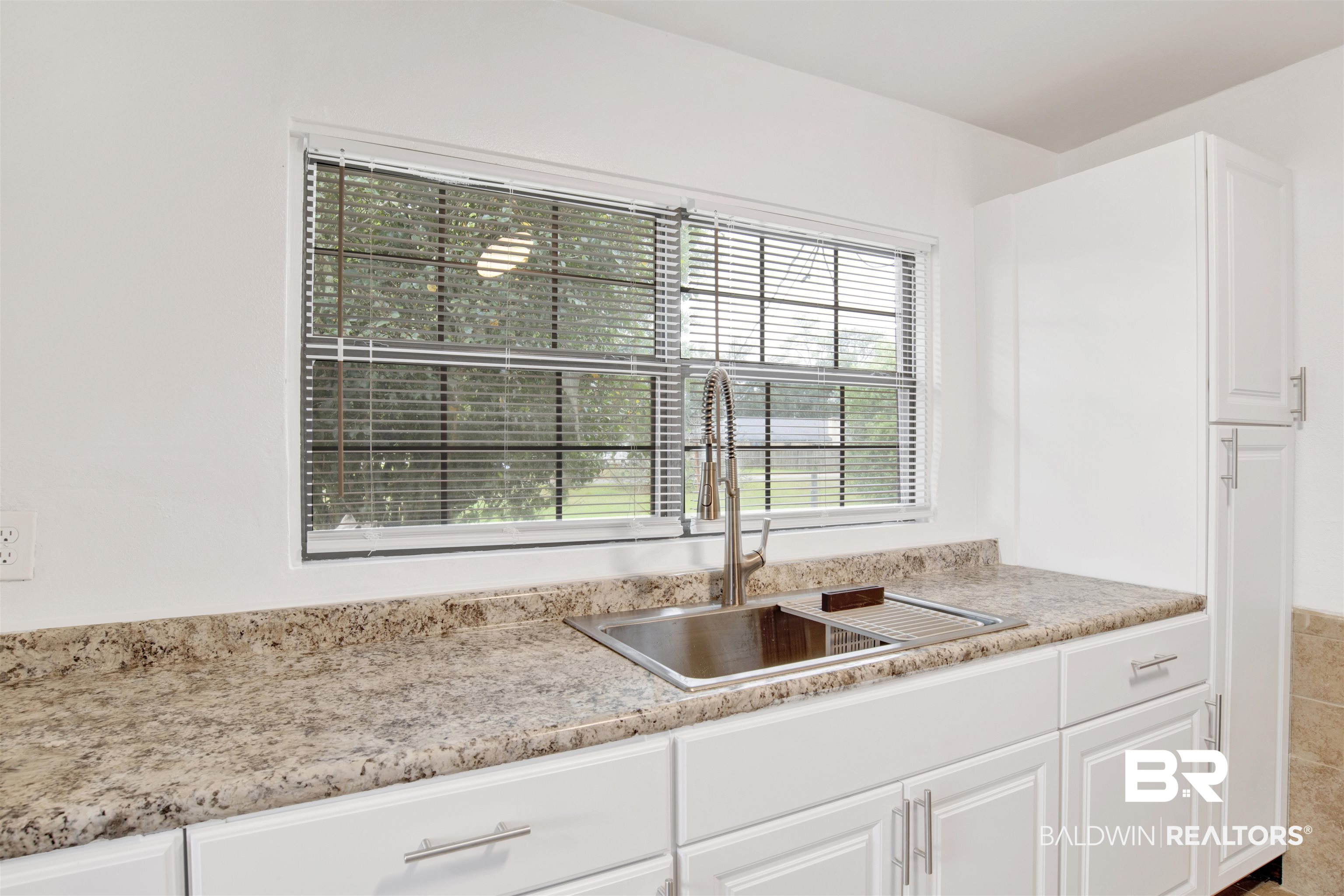 311 West Myrtle Avenue Foley, AL 36535 - Photo 12 of 22 Kitchen with sink and white cabinets