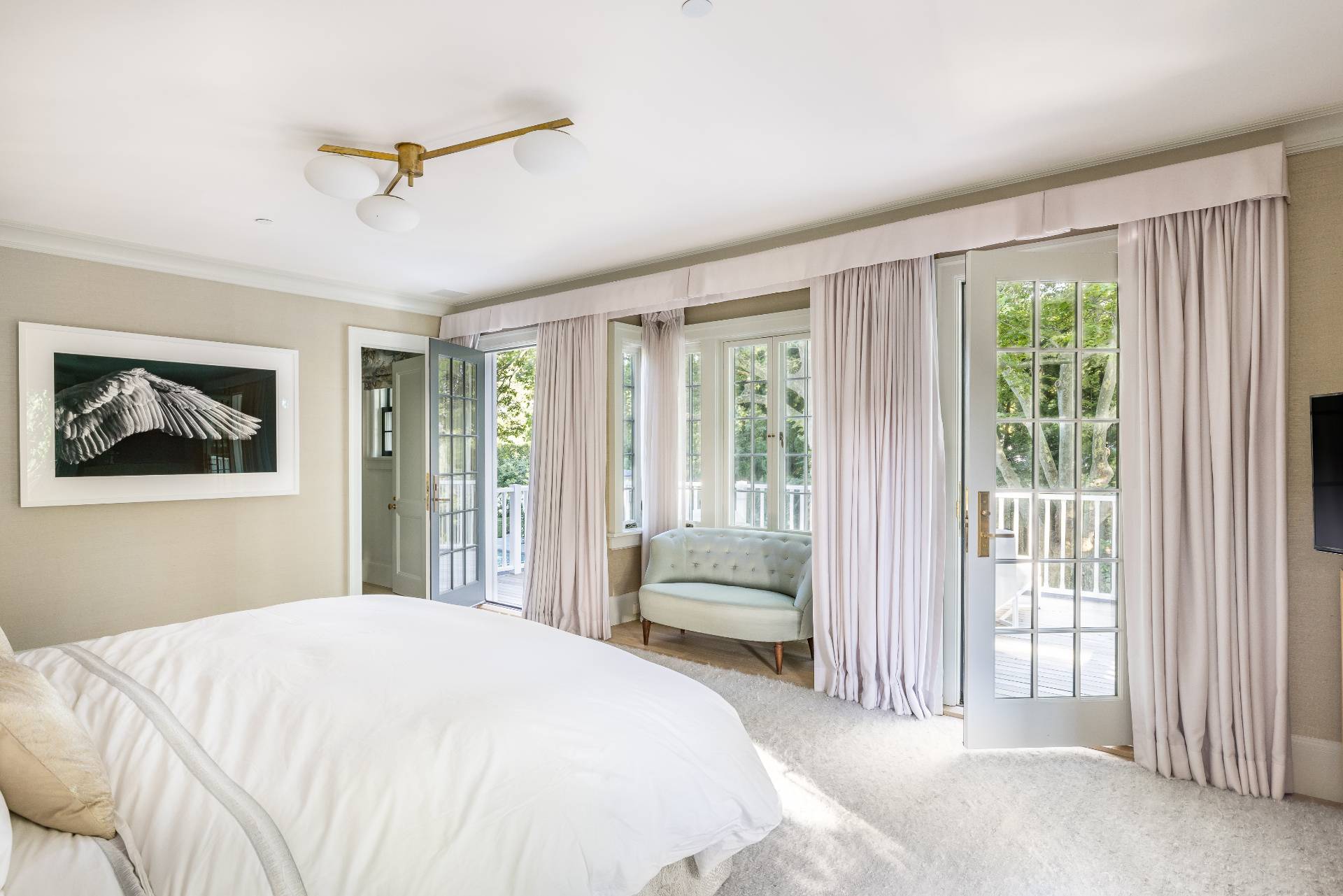 43 Lee Avenue East Hampton, NY 11937 - Photo 33 of 49 a bedroom with a bed and a painting on the wall