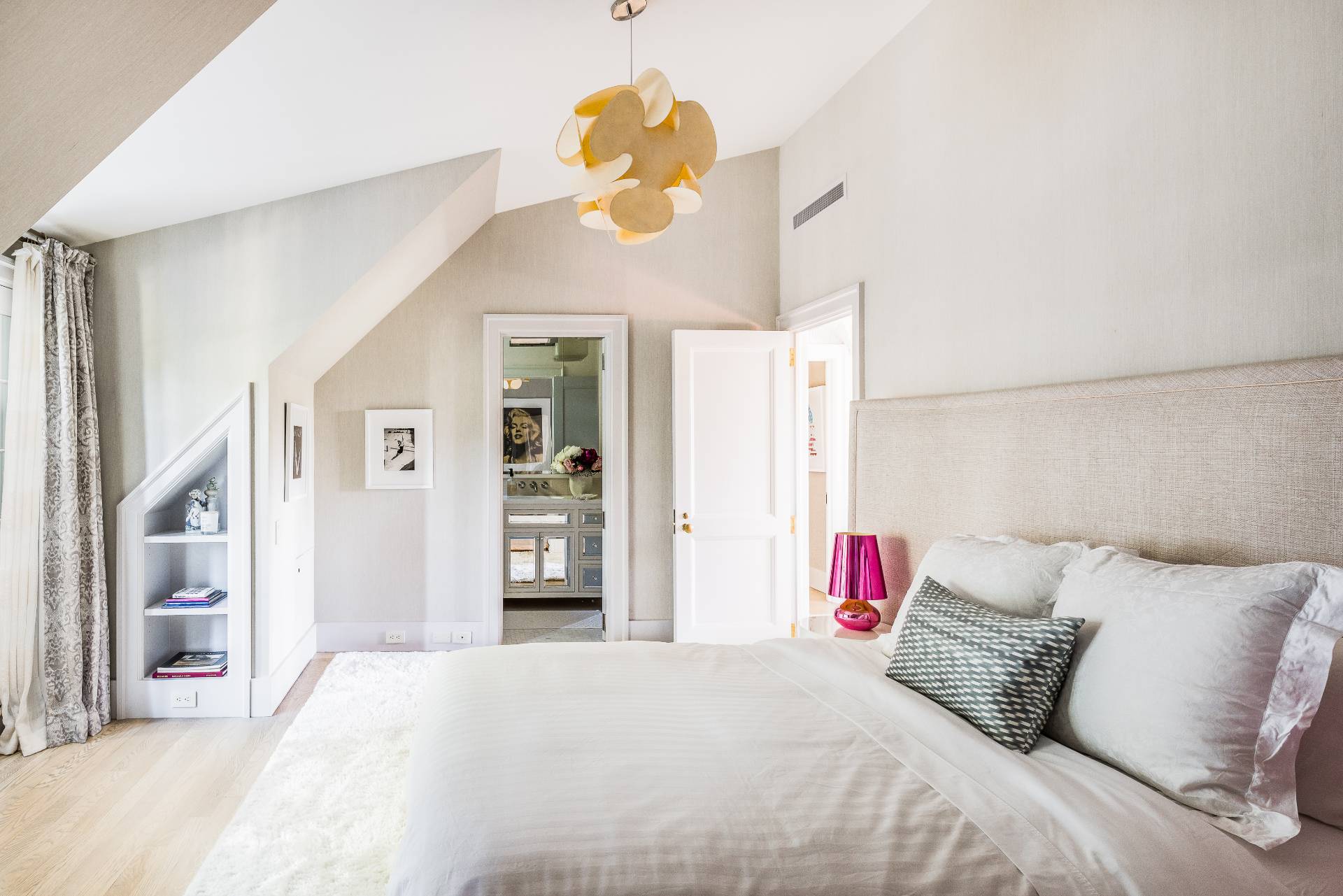 43 Lee Avenue East Hampton, NY 11937 - Photo 46 of 49 a bedroom with a bed and a chandelier